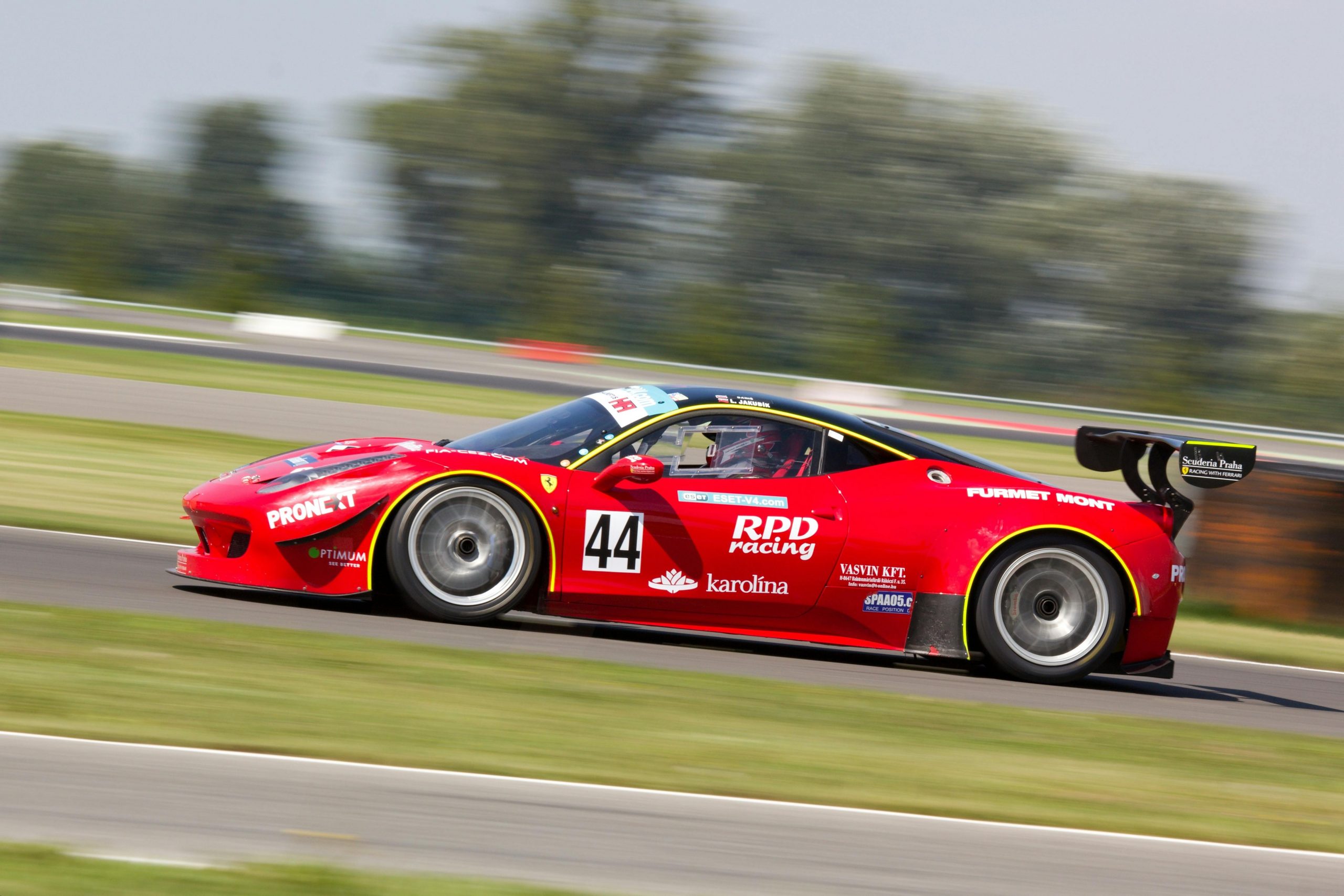 red race car speeding on the track