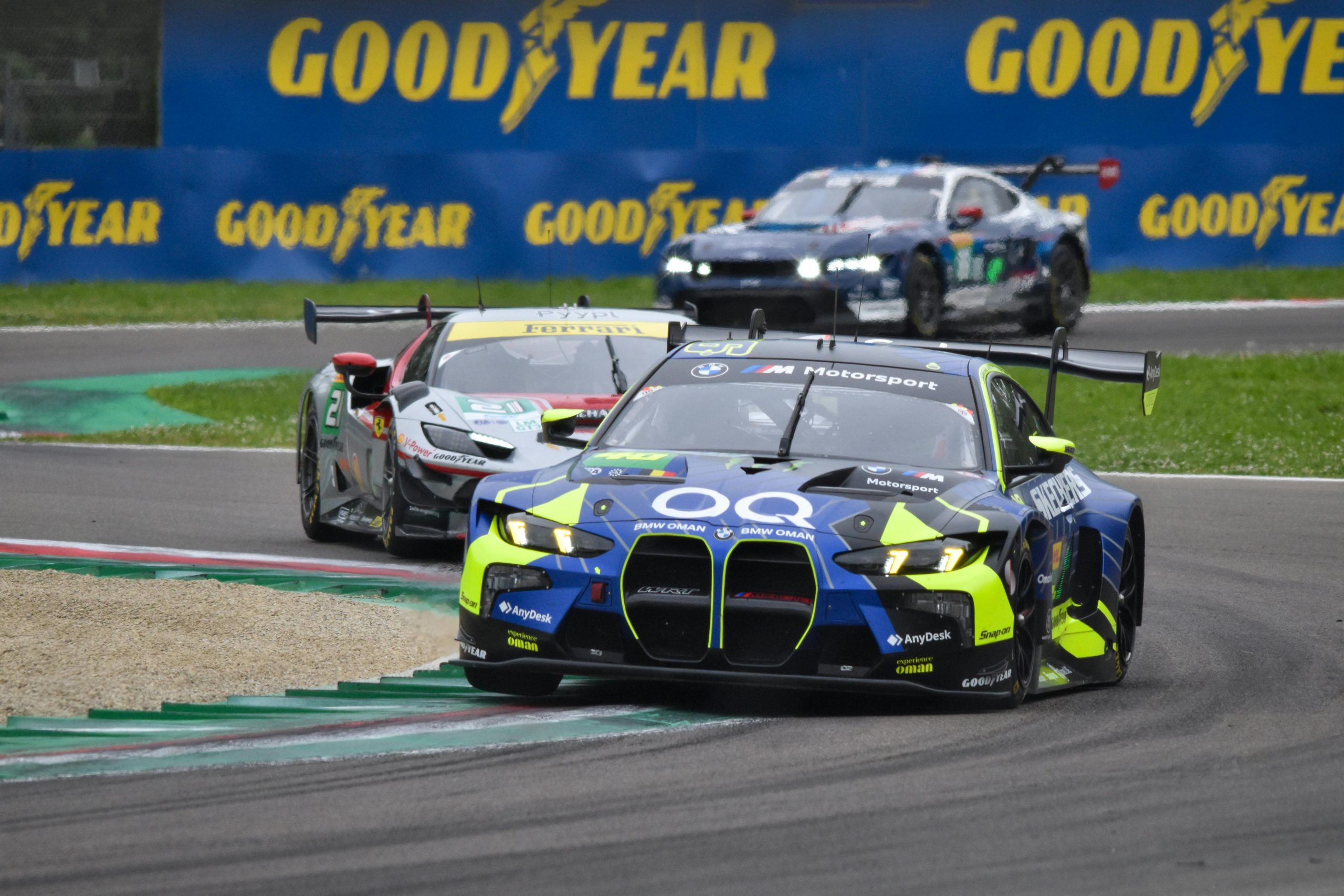 three race cars on a racetrack